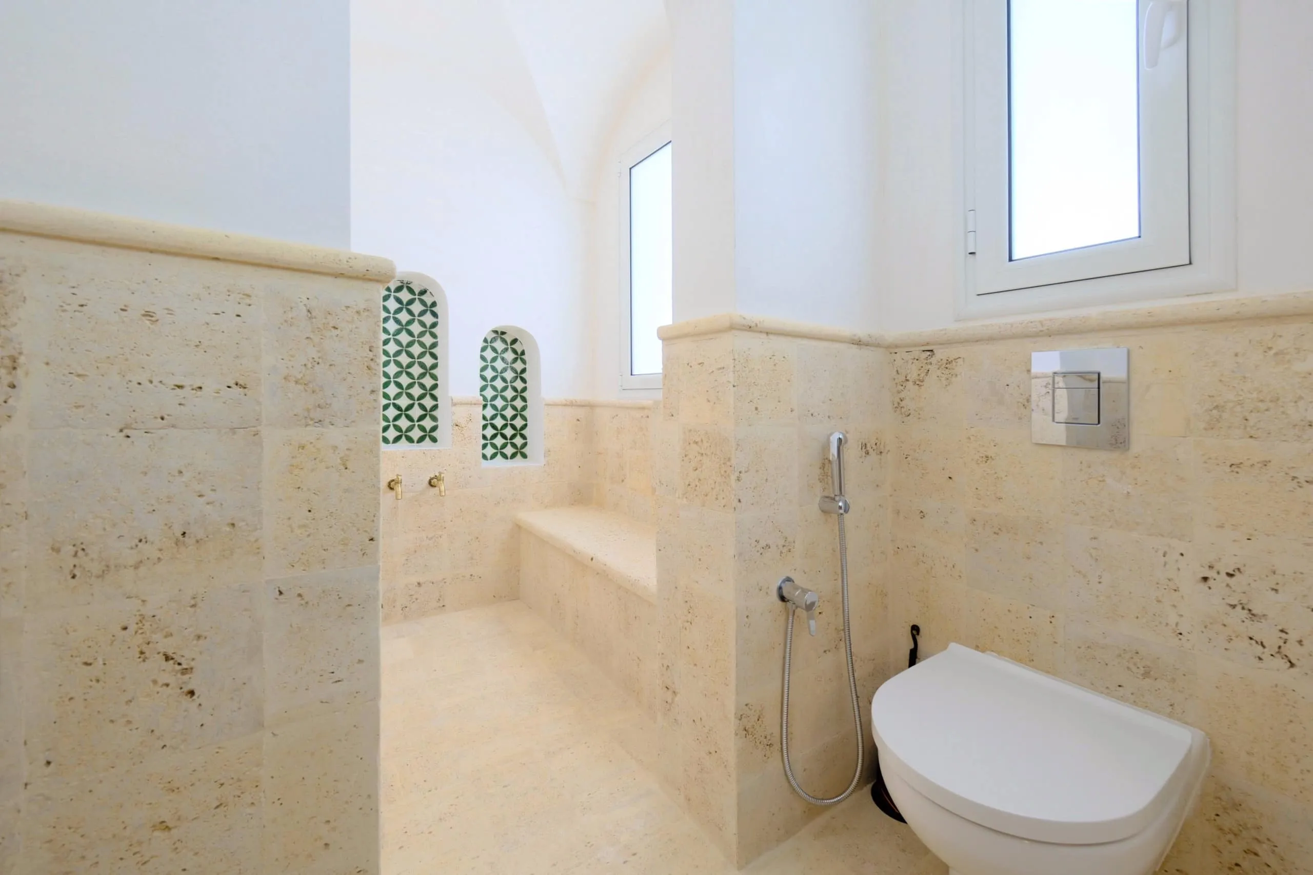 A bathroom in stone and zellige tiles