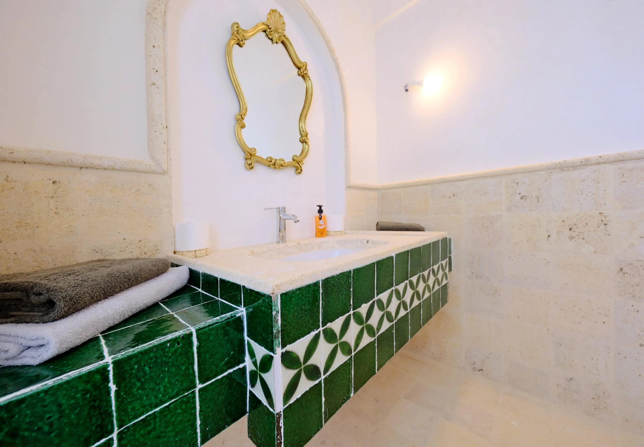 A bathroom in stone and zellige tiles