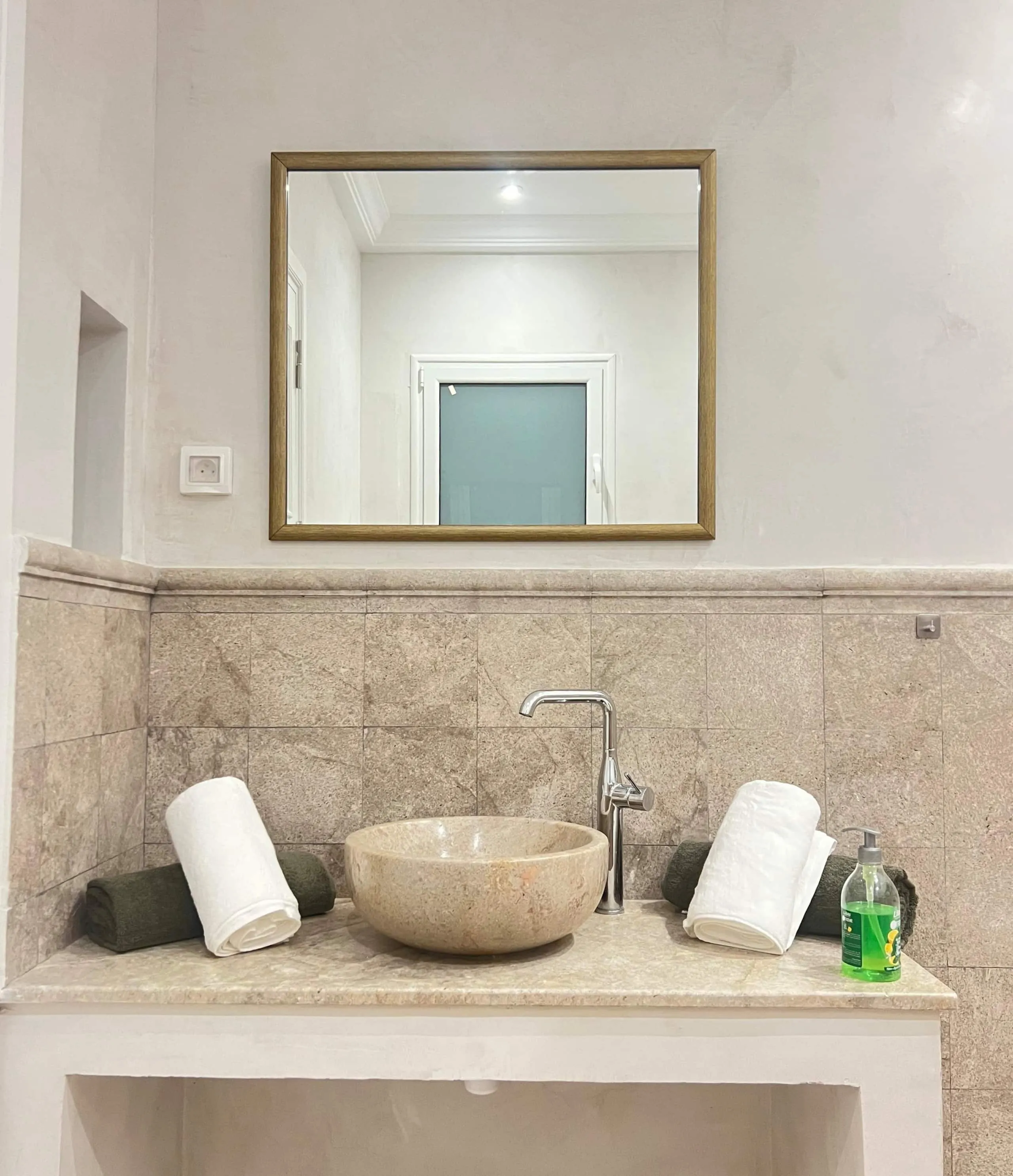 A bathroom in stone and zellige tiles