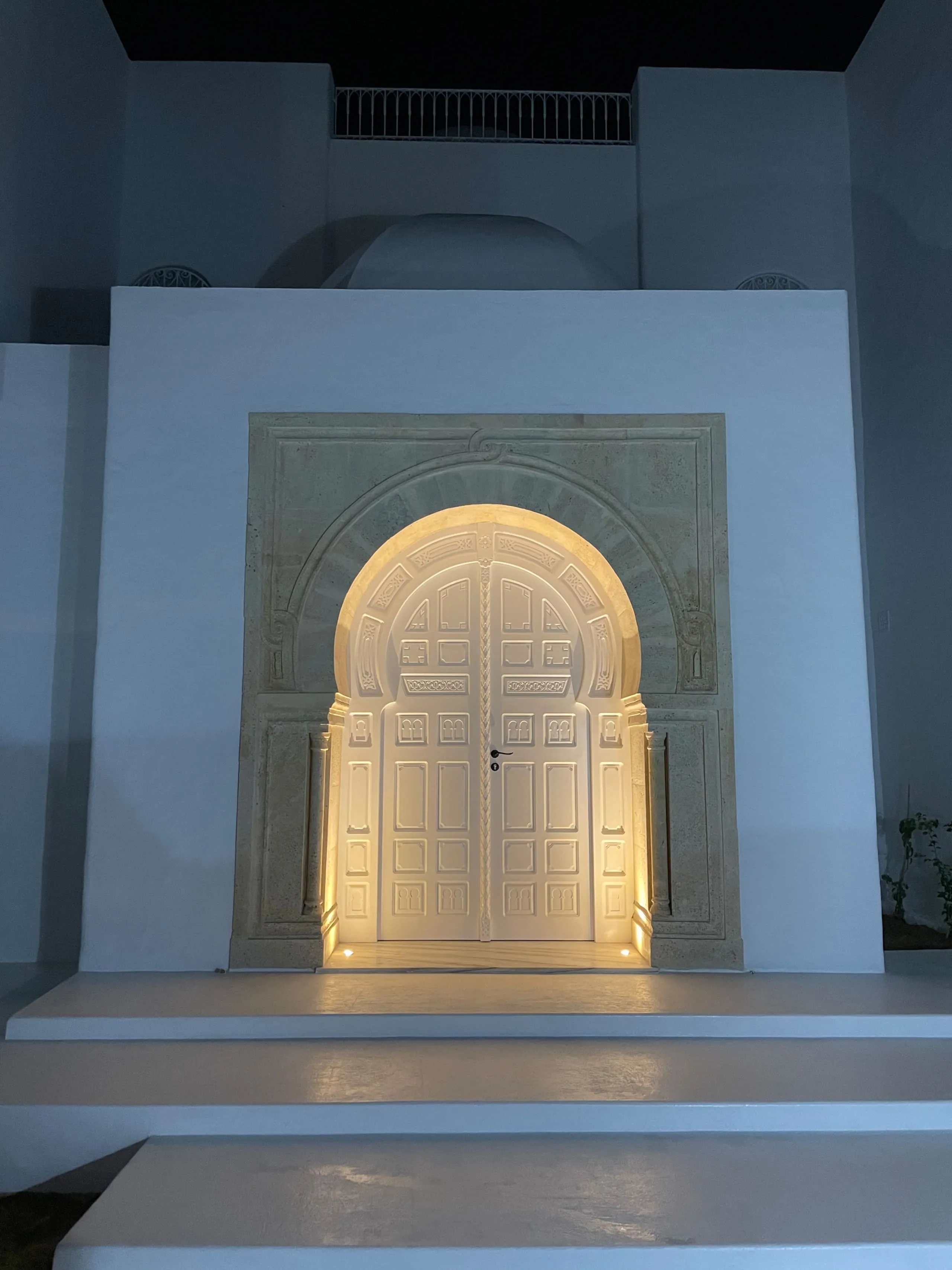 The entrance door lit up at night